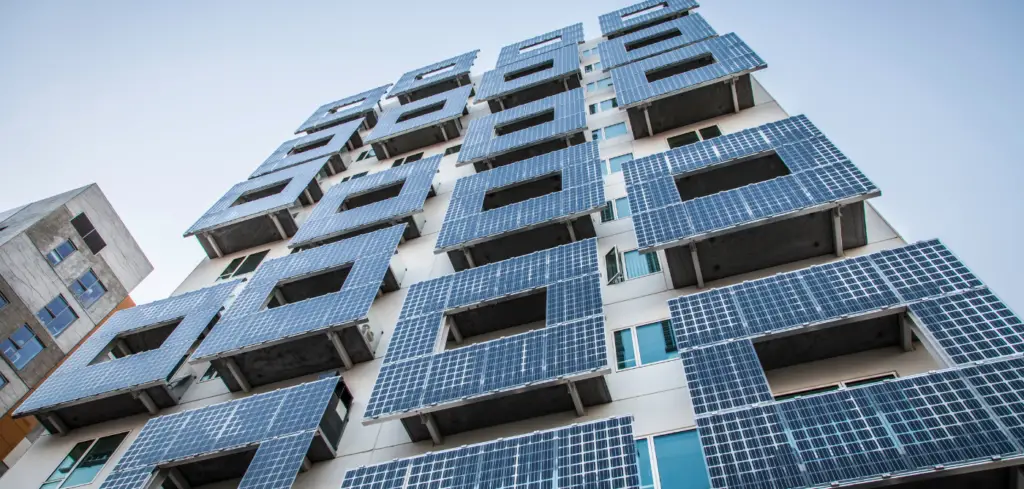 Modern apartment building with solar panels on the outside.