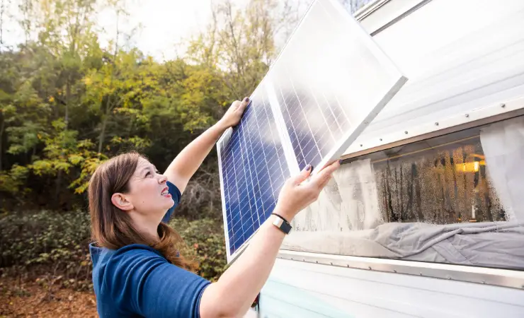 Woman installing solar panels on RV