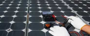 Solar technician testing solar panel.