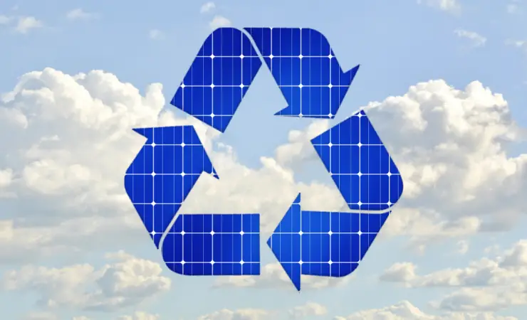Recycling icon made out of solar panels with a cloudy background