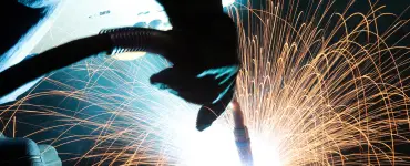 Up close shot of welding in progress. A lot of sparks coming off the focus point of the welder.