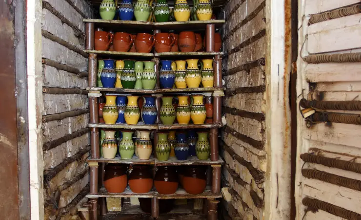 A home kiln with a lot of different pottery inside.